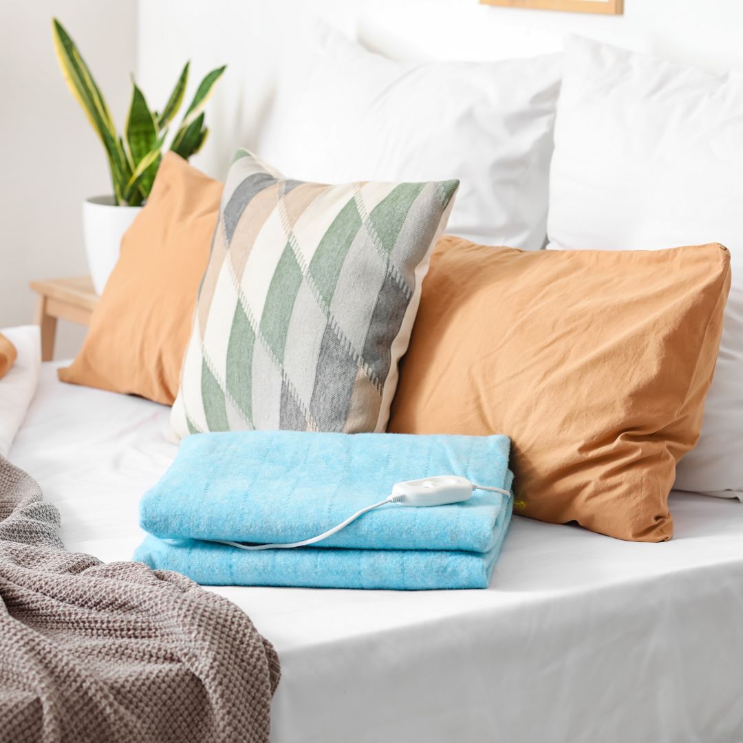 Bed with folded electric heating pad in bedroom