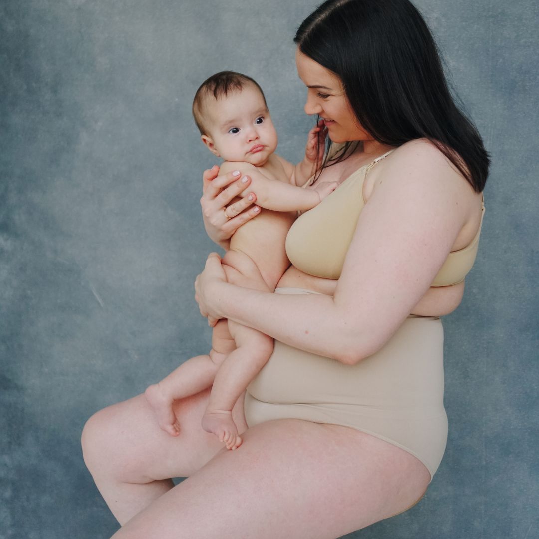 woman postpartum holding her baby