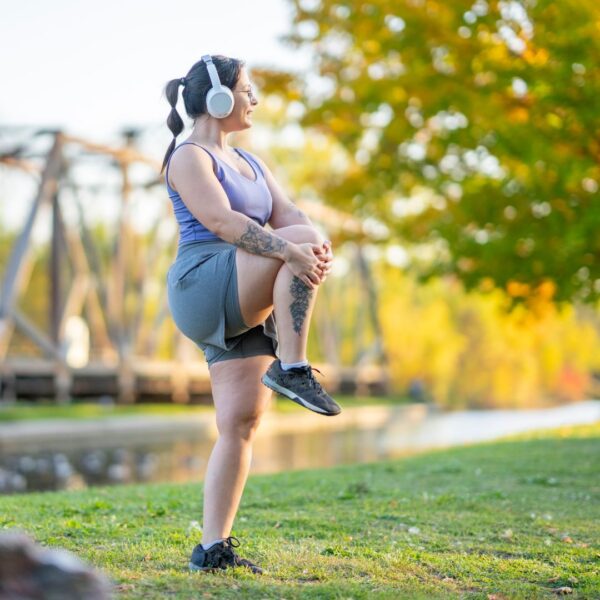 woman stretching with headphones on